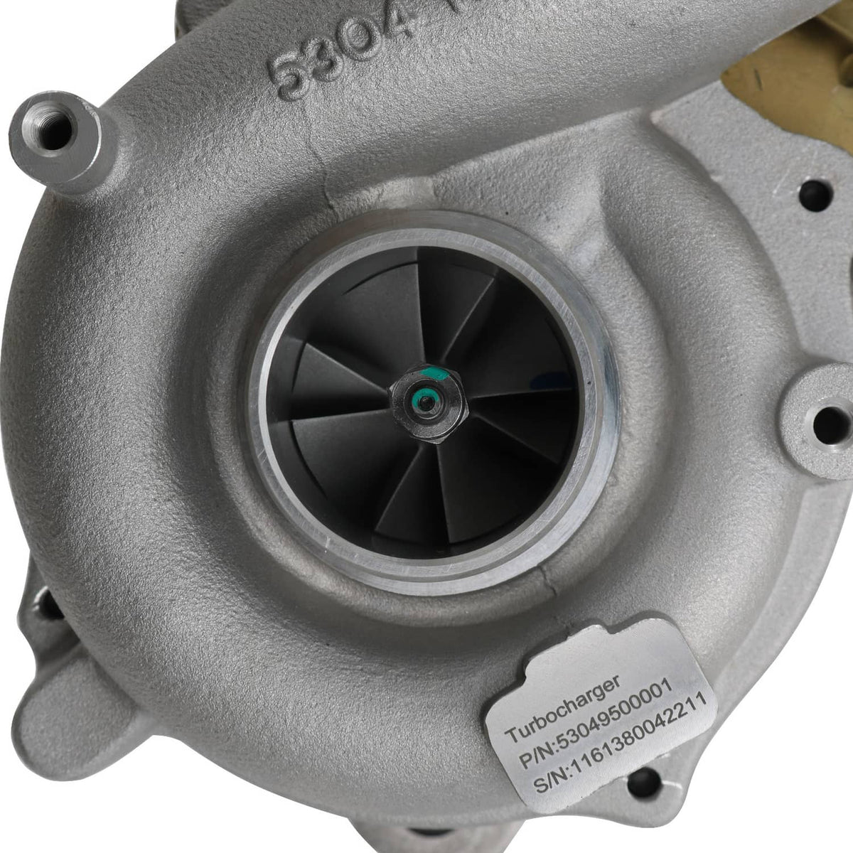 Close-up of turbocharger compressor wheel inside silver housing with identification label