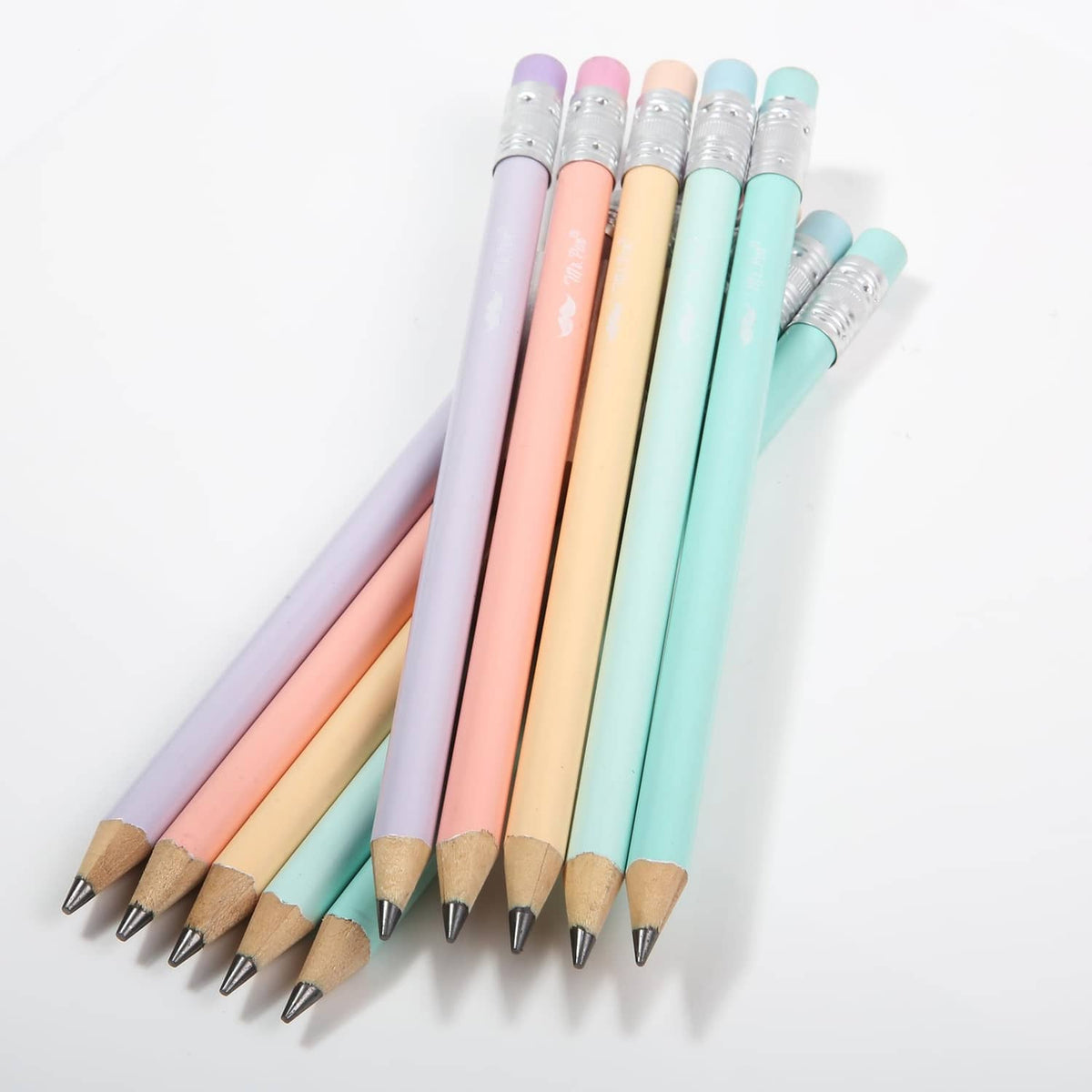 Pastel jumbo pencils fanned out with sharpened tips and silver ferrules on colorful barrels