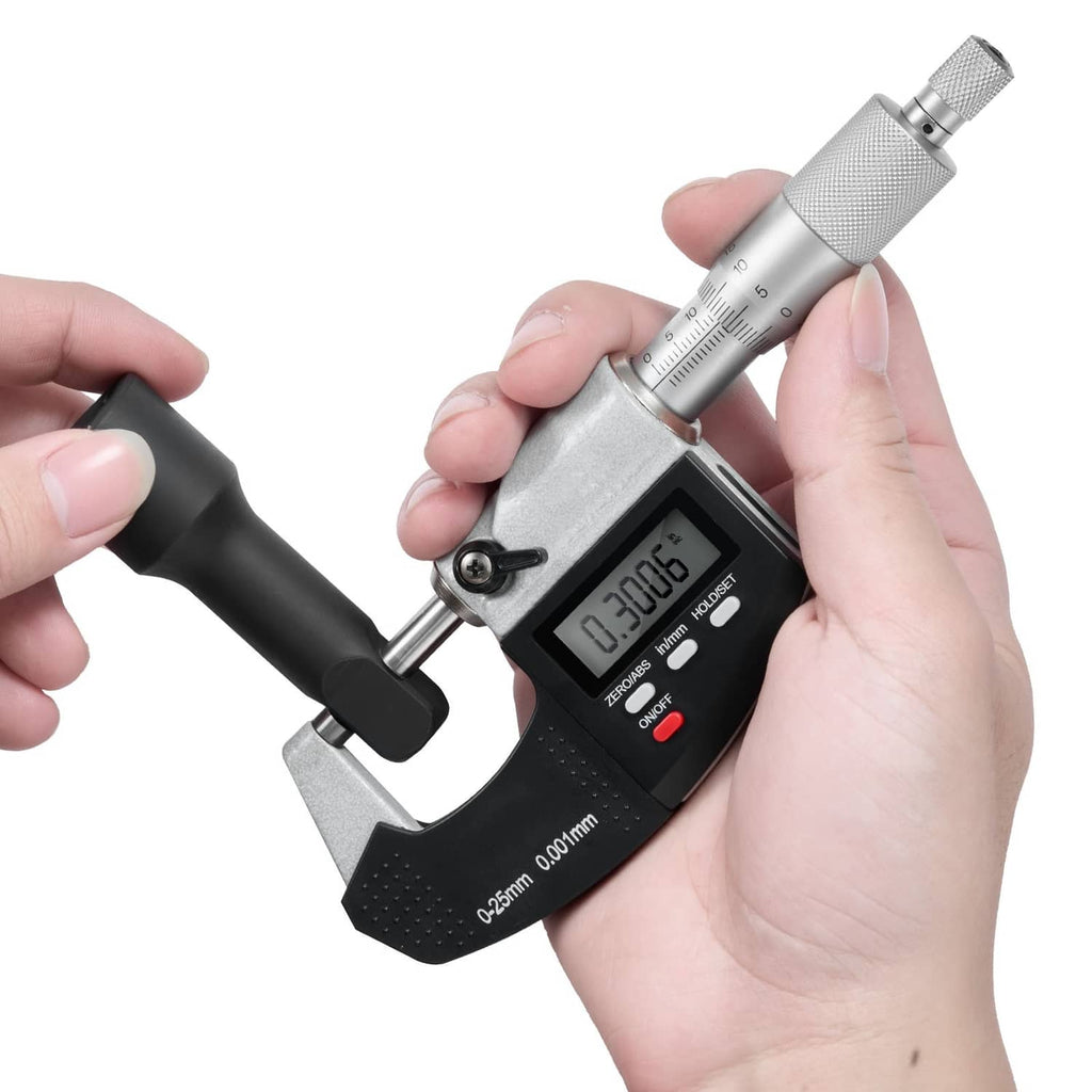 Digital micrometer with LCD display, silver body and black base, held in hand