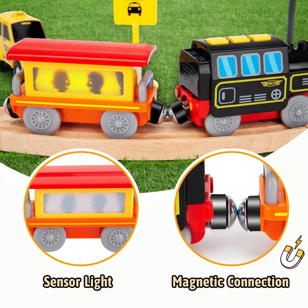 Orange passenger car and black locomotive paired together on wooden track