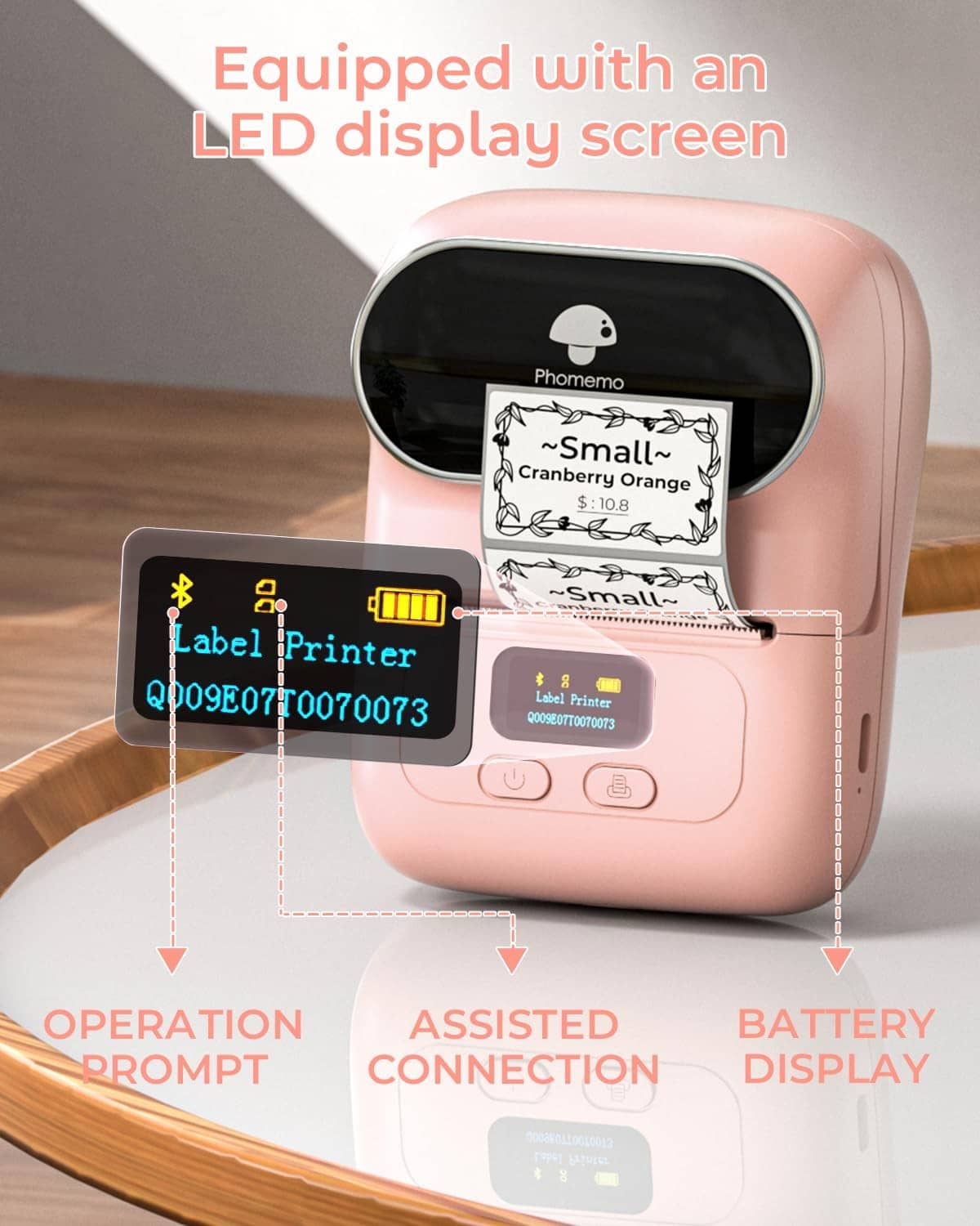 Pink thermal label printer with LED display screen and label output area visible.