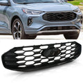 Black front grille with hex honeycomb pattern and center emblem opening