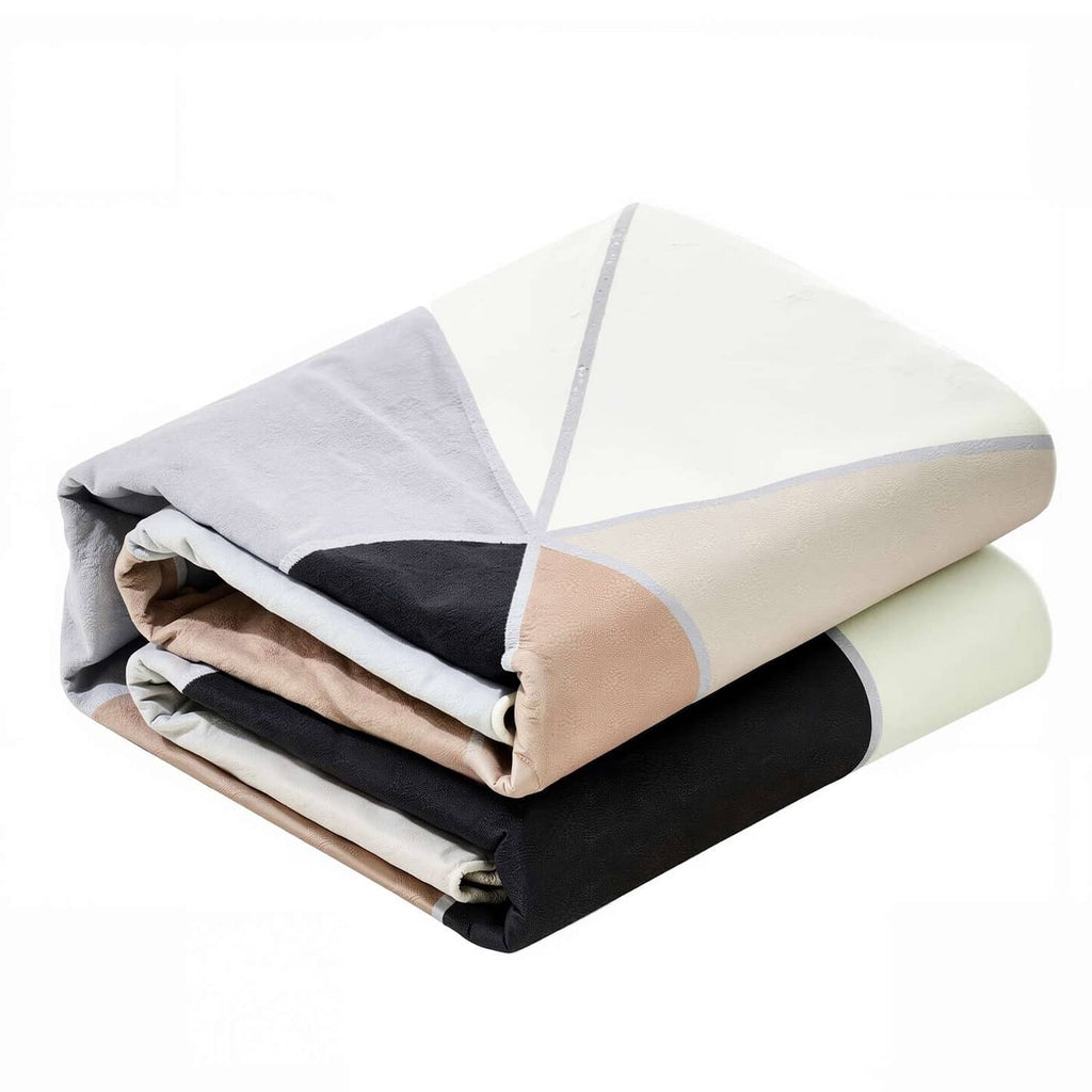 Folded indoor area rug, layered charcoal gray and cream tones with non-slip backing