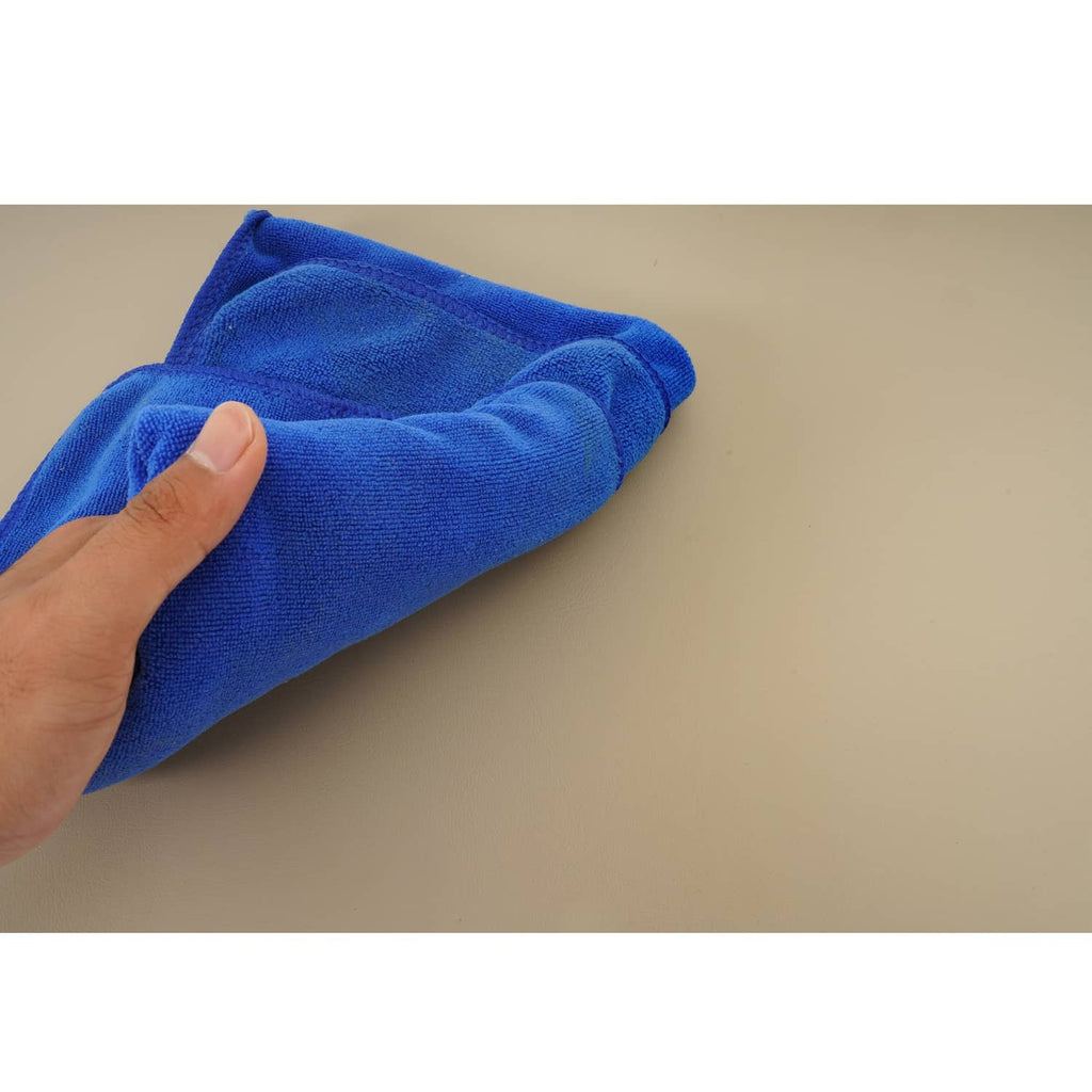 Tan cushion surface wiped with blue microfiber cloth