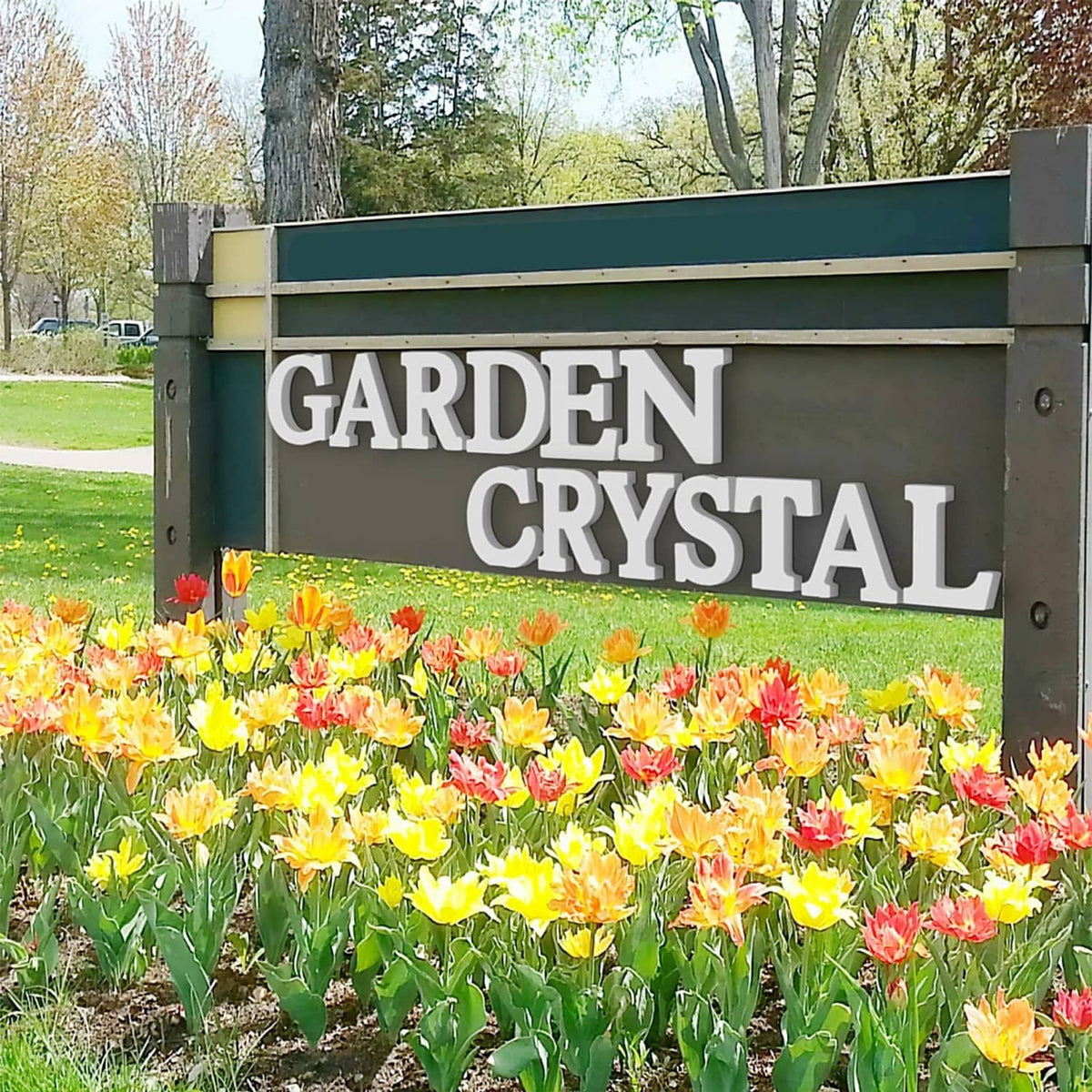 White wooden letter sign reading GARDEN CRYSTAL