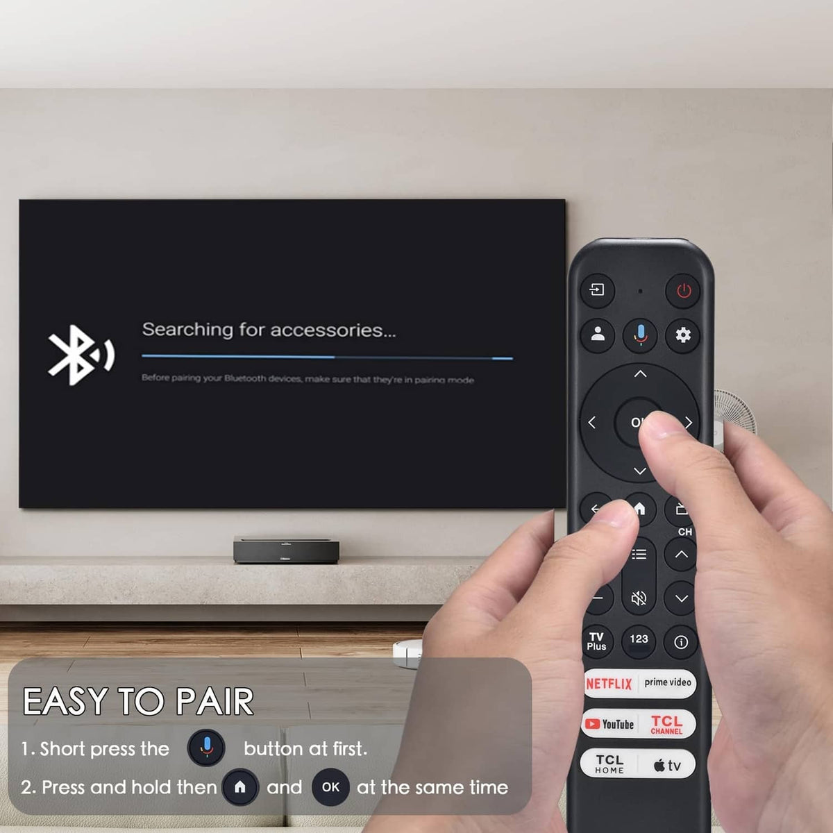 Black TV remote being paired, finger pressing OK and navigation controls