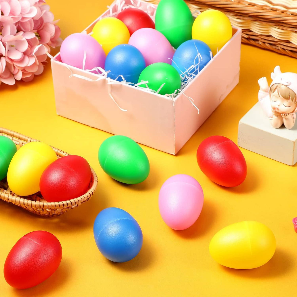 Plastic egg shakers in an open box with colorful red blue green yellow pink eggs