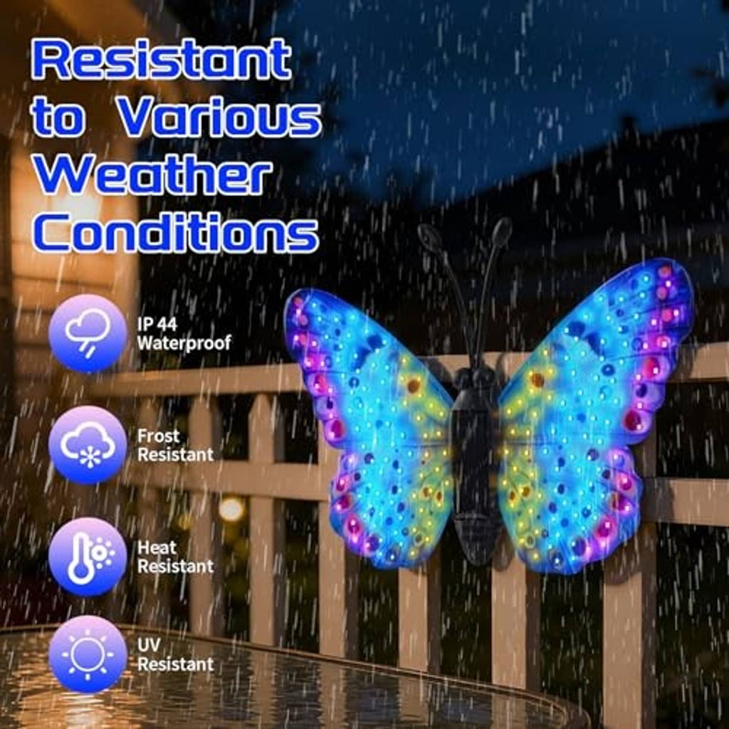 Solar LED butterfly wall decor with multicolor glowing wings, shown outdoors in rain