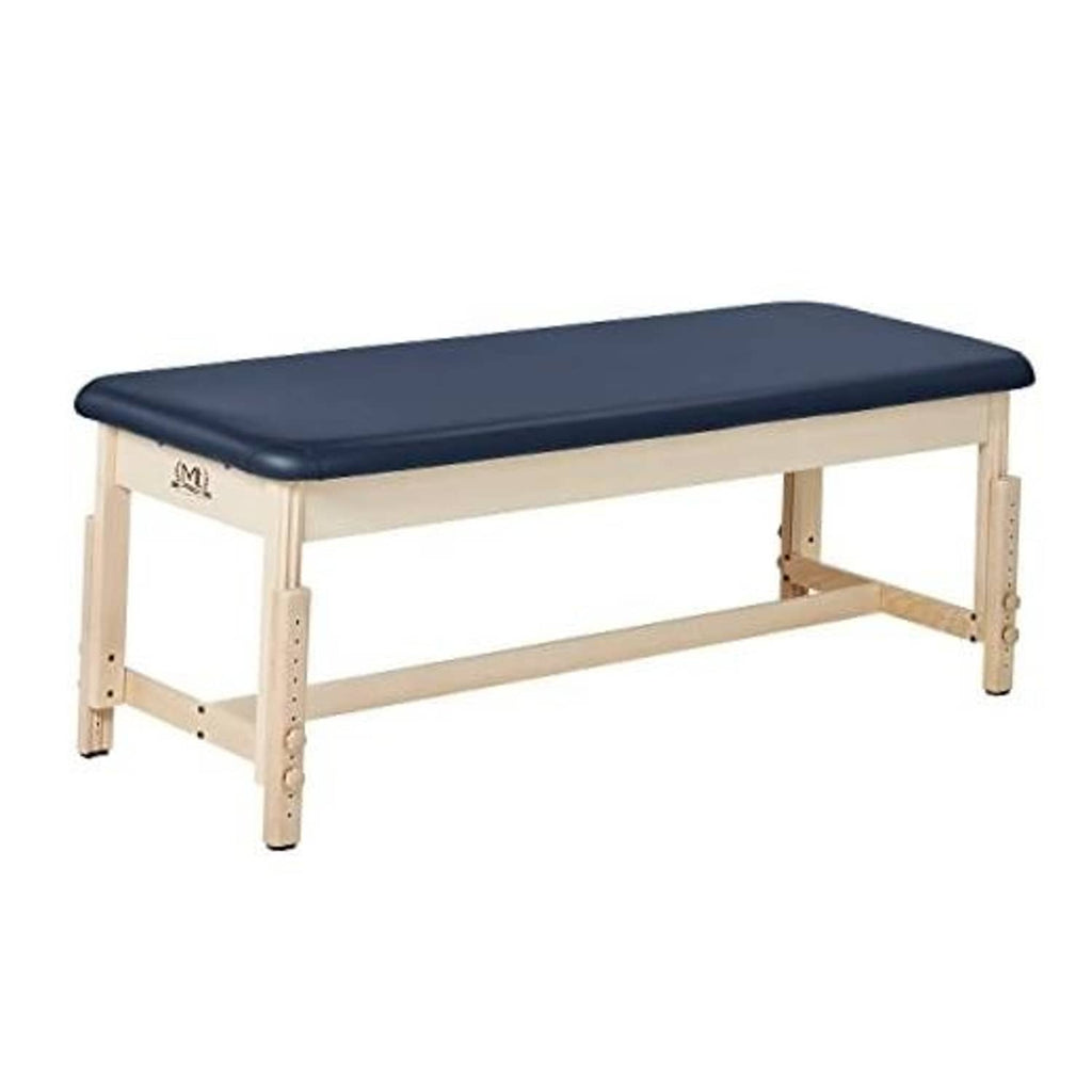 Stationary treatment table with dark blue padded top and light wood frame