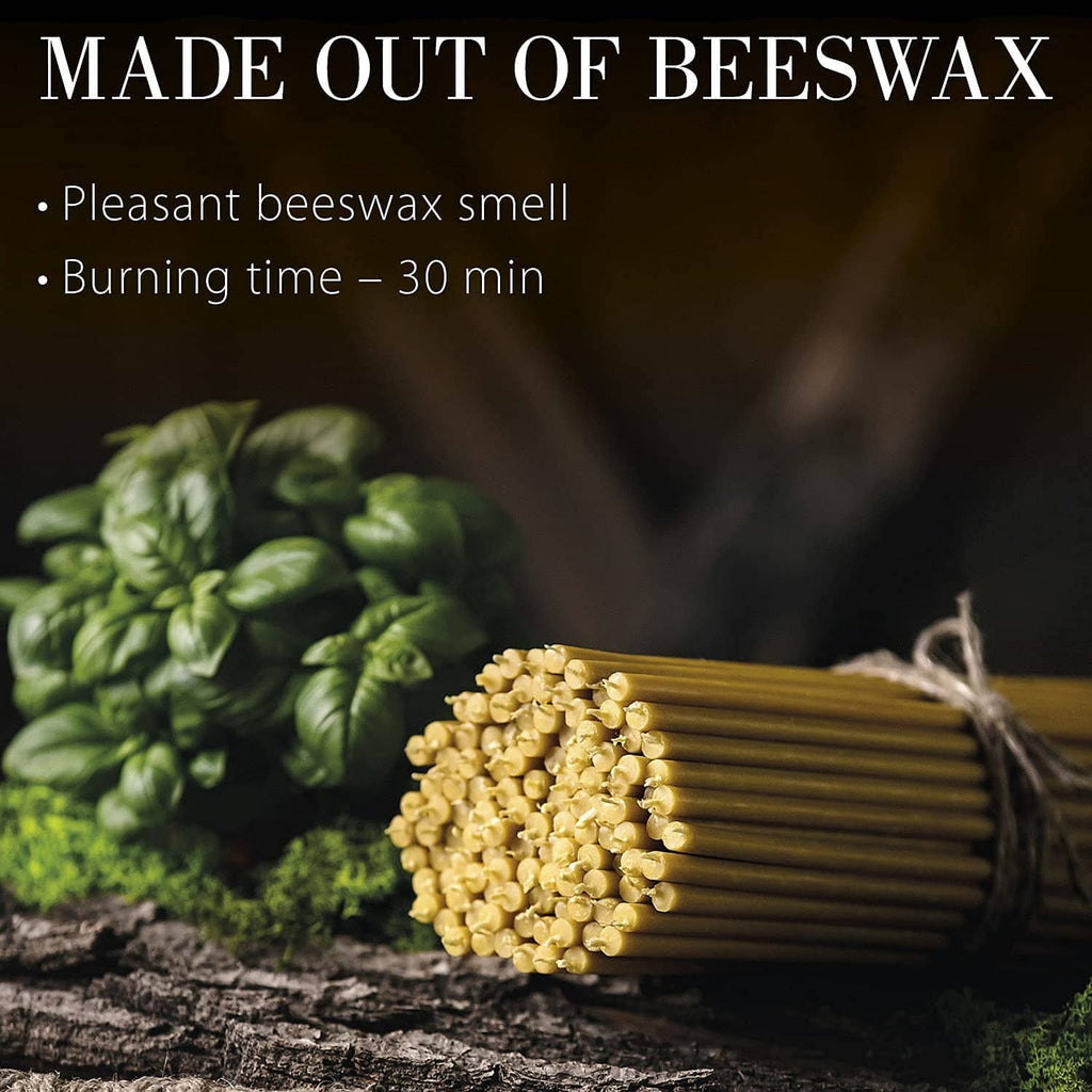 Beeswax taper candles bundle with cut ends, arranged on a dark wooden surface.