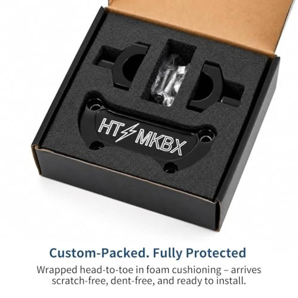 Black handlebar riser top clamp kit in foam-lined protective packaging