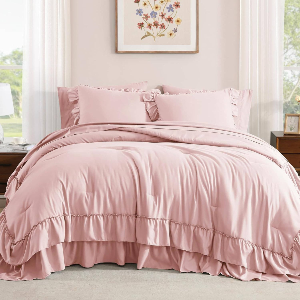 Blush pink queen comforter and pillow shams with layered ruffle trim on bed