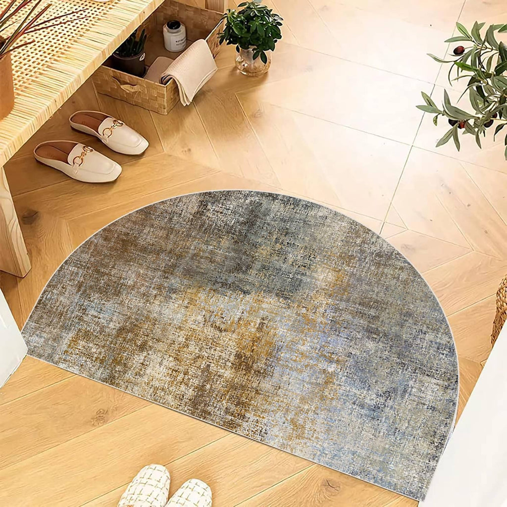 Semicircular mottled doormat in blue, gray, and tan with flat woven texture