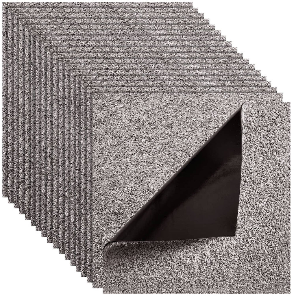 Self-adhesive carpet tile with speckled dark gray surface and layered backing visible