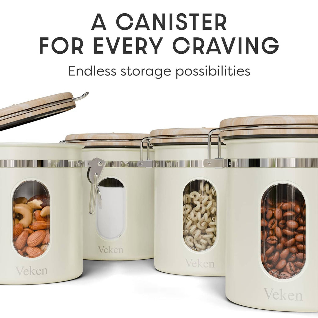 Multiple cream stainless canisters with oval viewing windows and front clamp handles