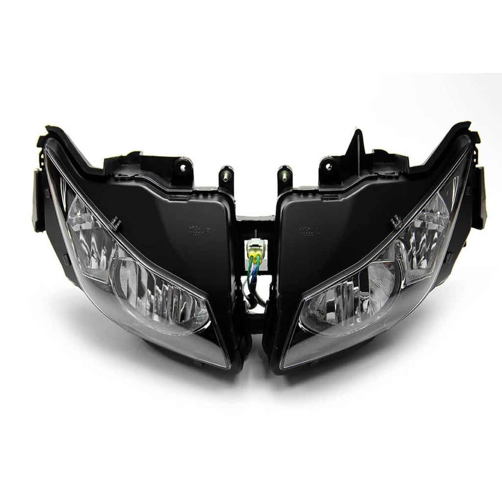 Pair of black headlight housings with clear lenses and internal wiring connector