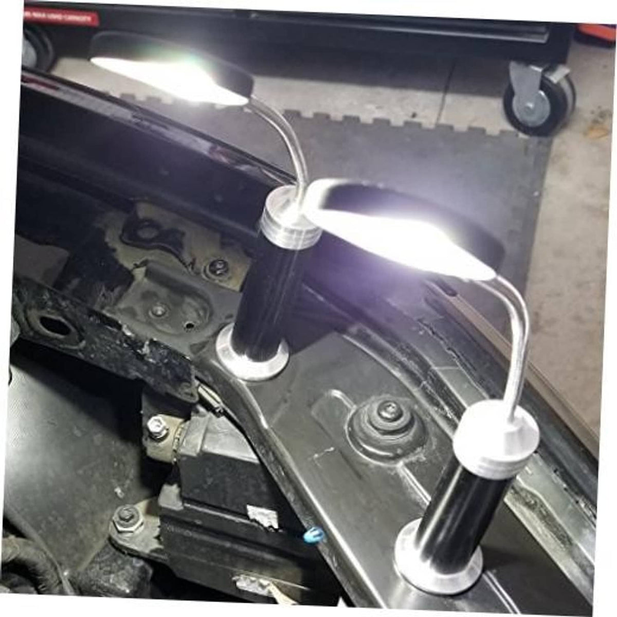 Magnetic LED COB light set with three black posts and chrome bases on car engine bay