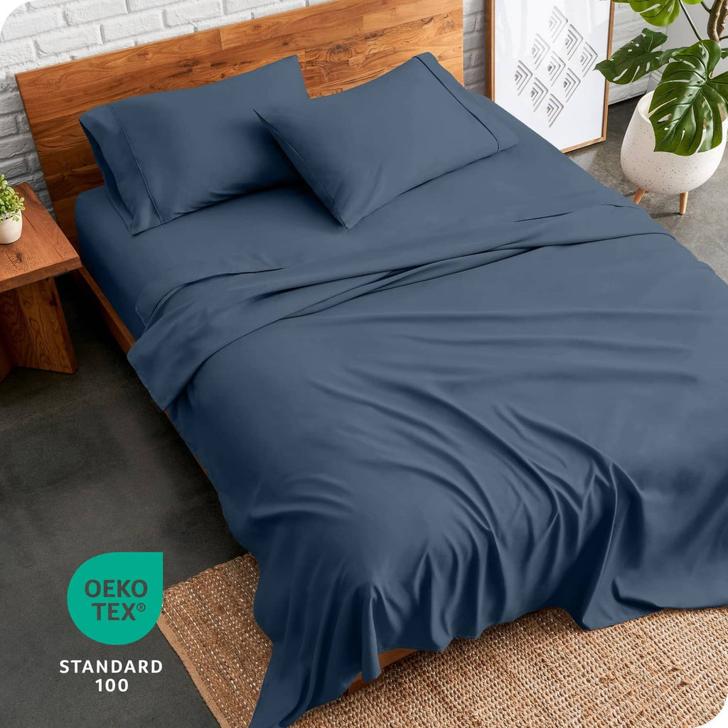 Blue twin bed linen set with fitted sheet and two pillowcases neatly arranged
