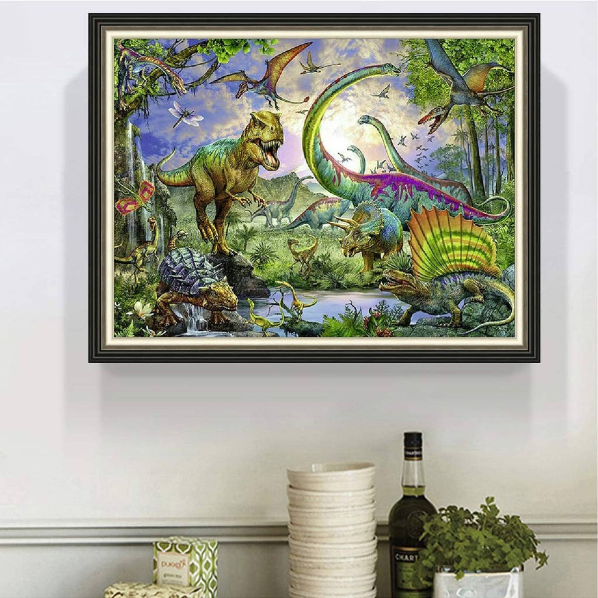 Framed diamond art painting showing colorful dinosaurs, flying creatures, and plants.