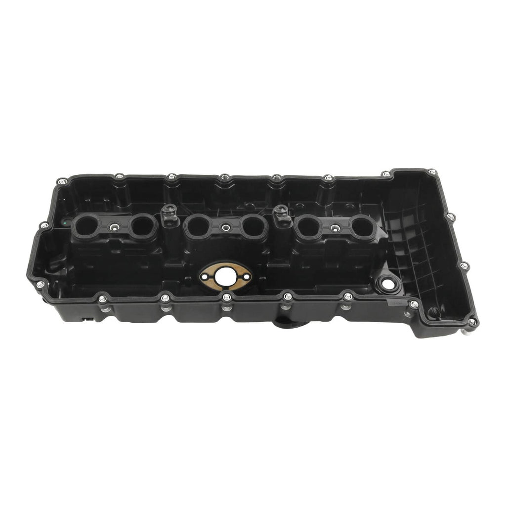 Black valve cover with ports and bolt holes, top view on white background