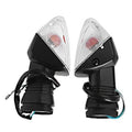 Pair of motorcycle turn signal indicator lights with clear lens, black housing, and wiring