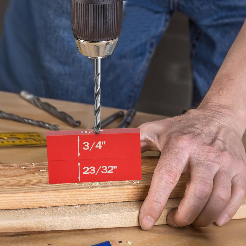 Red height gauge block positioned under a drill bit on a wooden workpiece