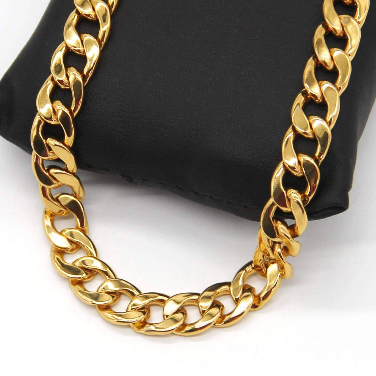 Gold chain necklace shown on a black display cushion