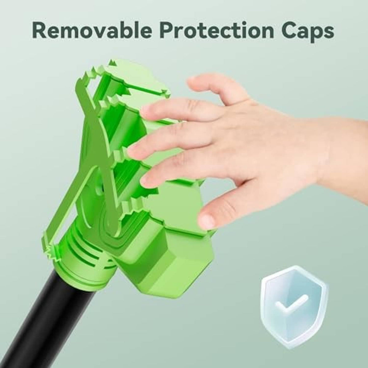 Green outlet adapter with removable protection caps, hand shown near black cord