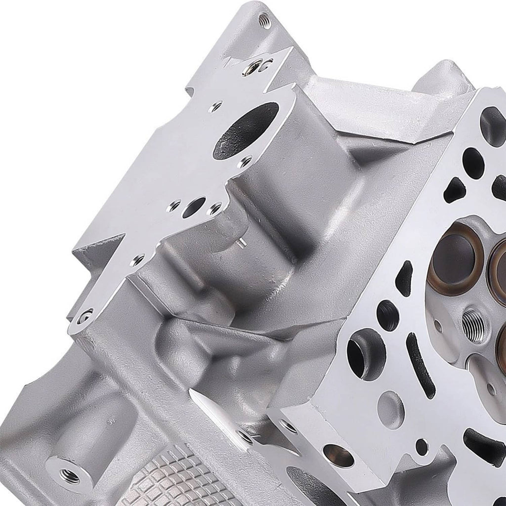 Silver gray cylinder head with bolt holes, oil passages, and intake/exhaust ports