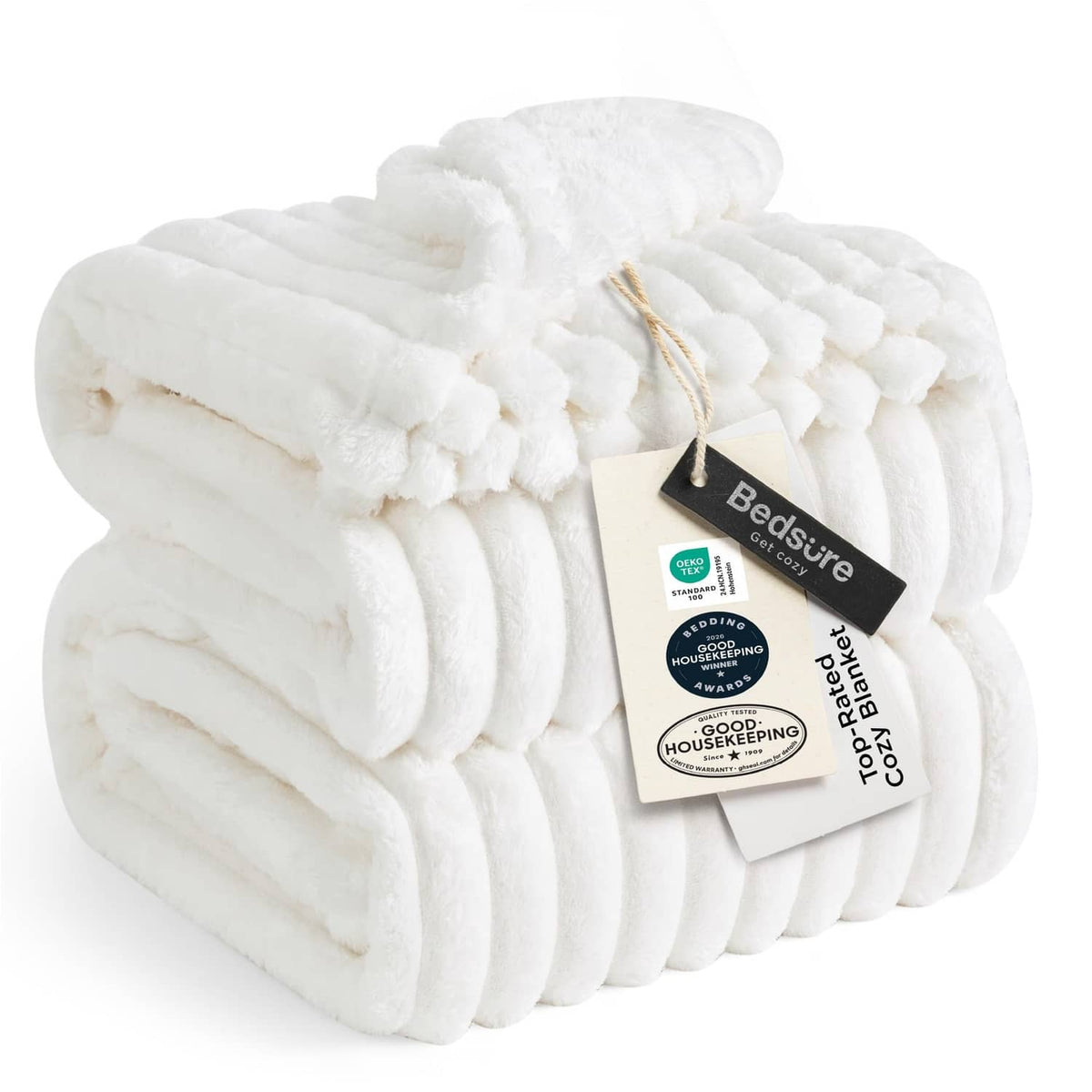 Off-white ribbed fleece blanket with pom-pom trim and folded edge detail