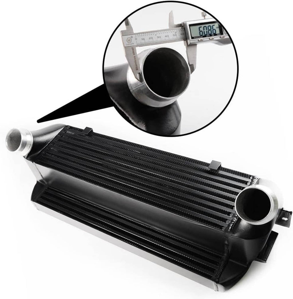 Front-mount intercooler with black finned core, circular metal ports, and measuring scale