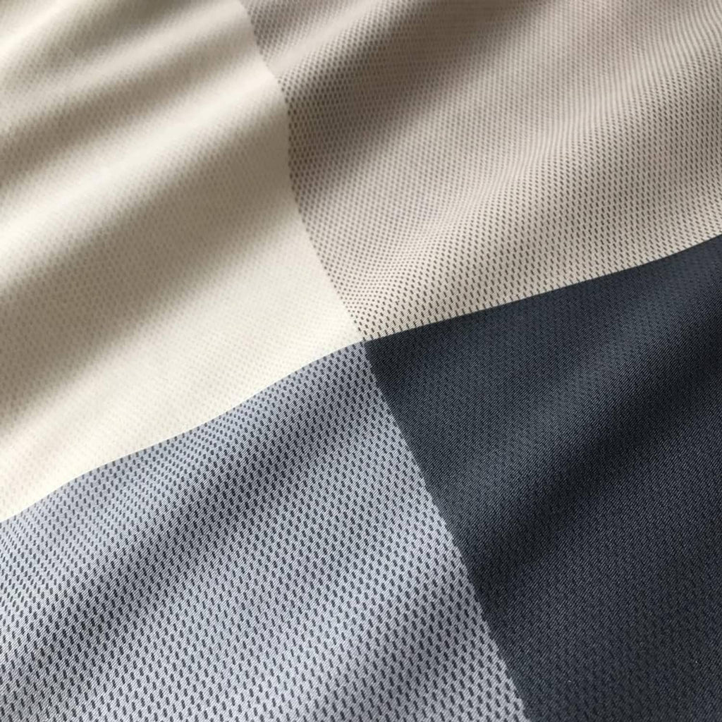 Navy and white checkered comforter fabric with fine textured weave close-up