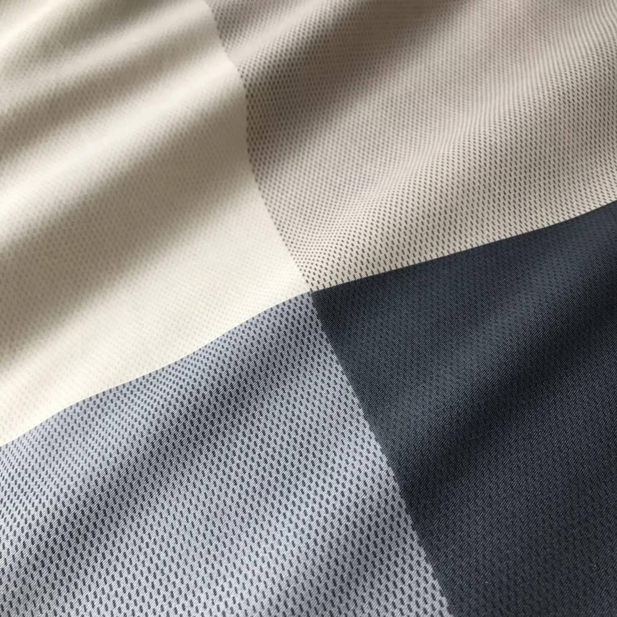 Navy and white checkered comforter fabric with fine textured weave close-up