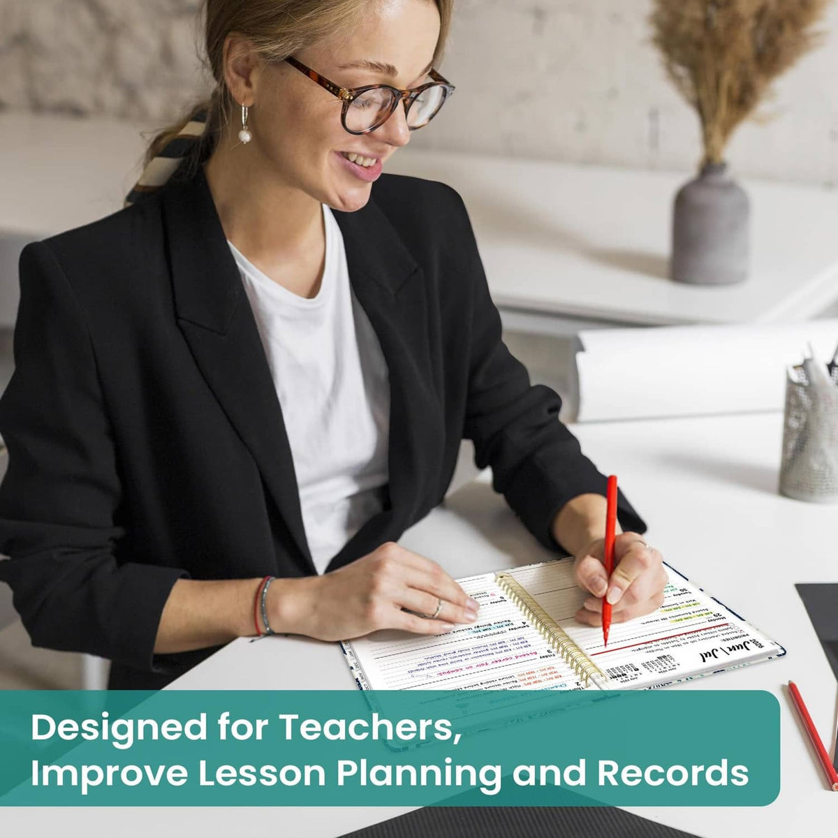 Person writing in spiral academic planner on desk, showing week calendar layout