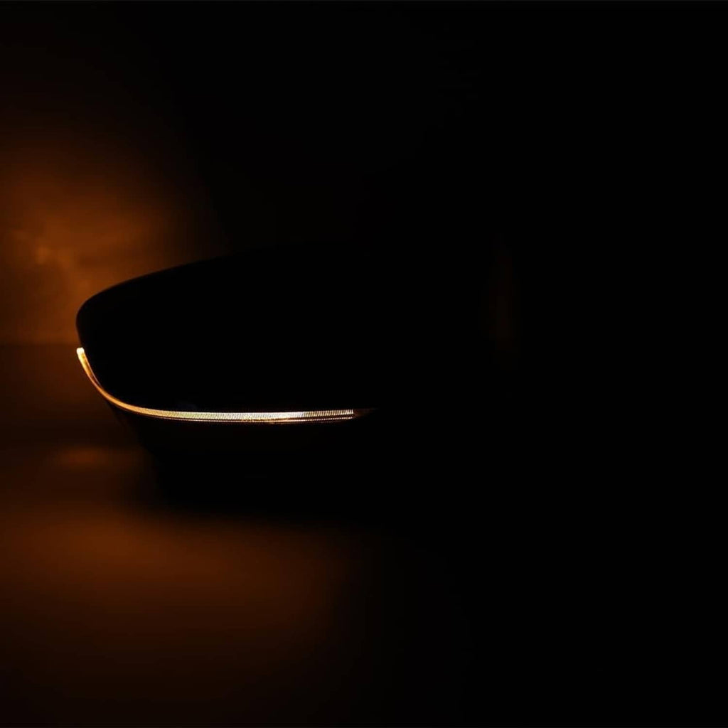 Passenger side mirror indicator glowing amber along the mirror edge