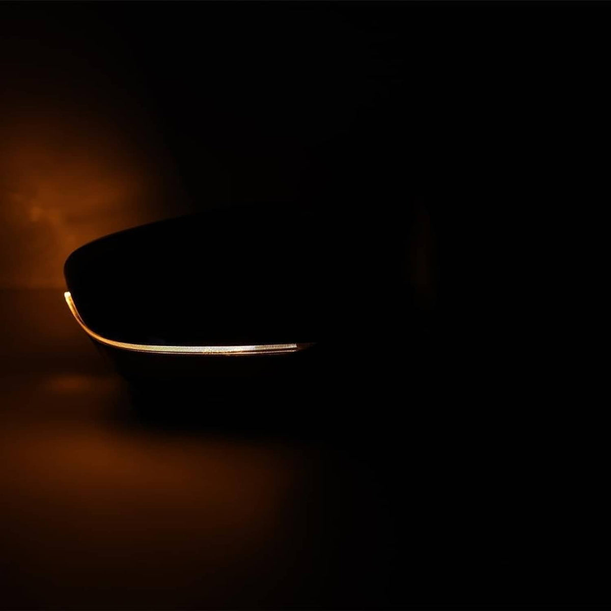 Passenger side mirror indicator glowing amber along the mirror edge