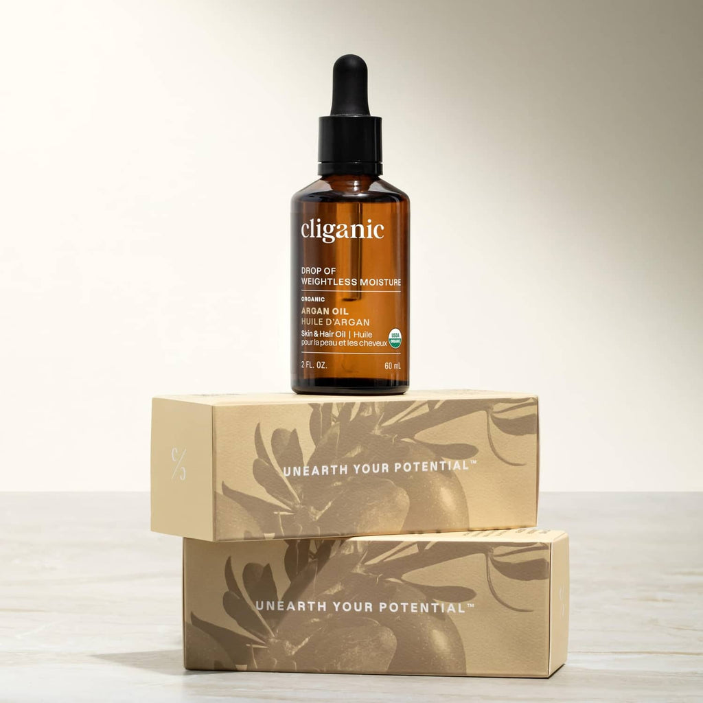 Cliganic argan oil bottle on top of two cardboard boxes