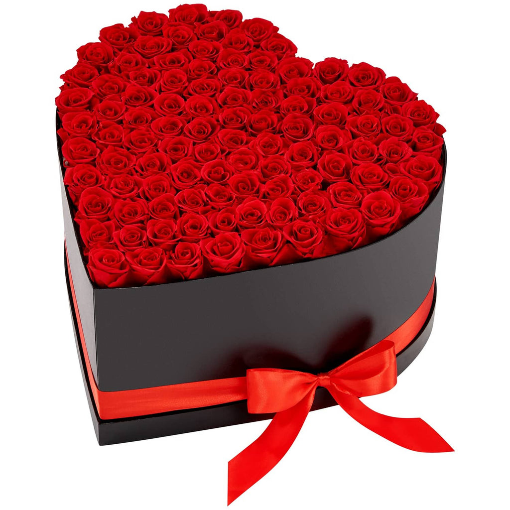 Heart-shaped black rose box filled with red roses, orange-red ribbon bow on front
