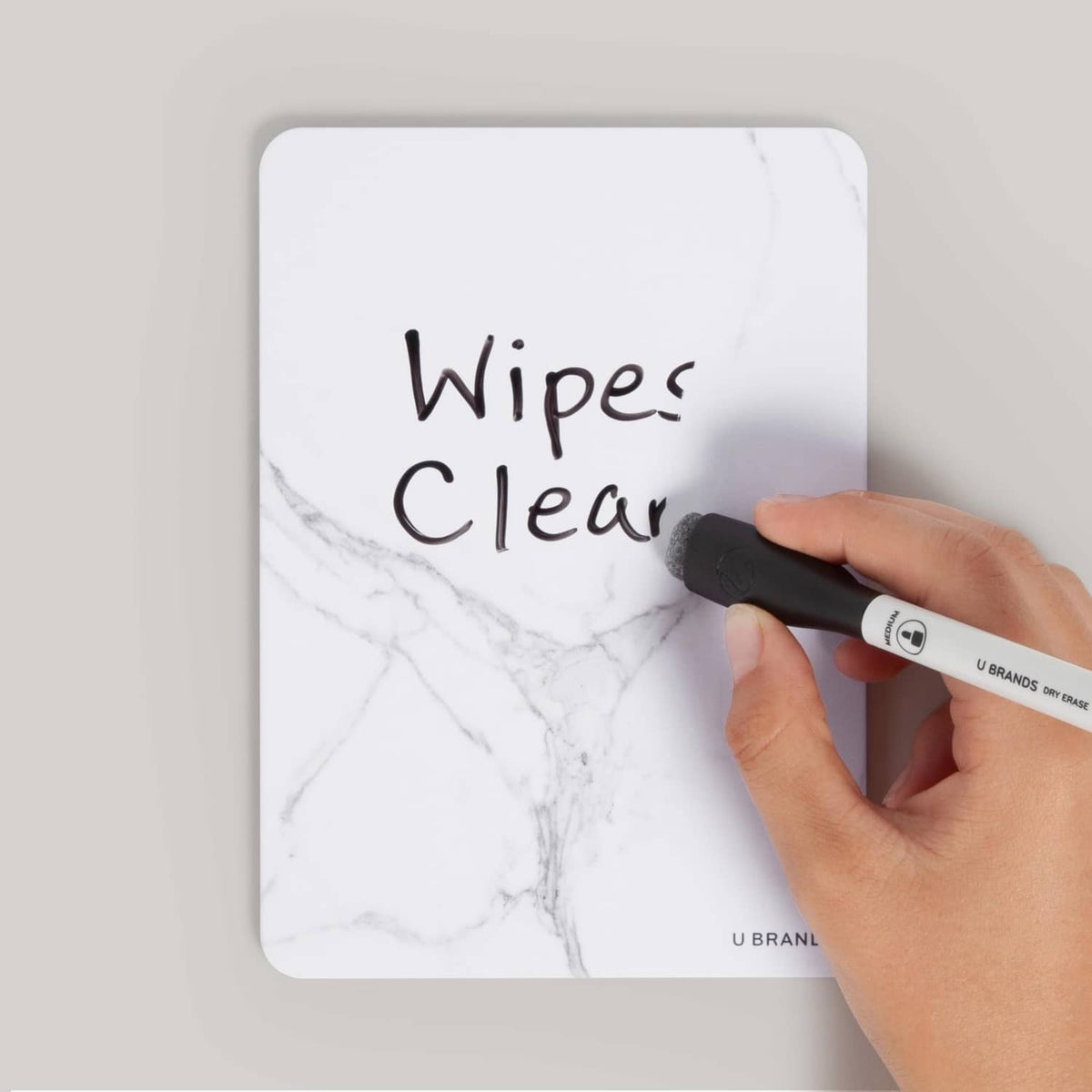 Wipe-clean marble board with a black bullet tip marker and printed writing surface