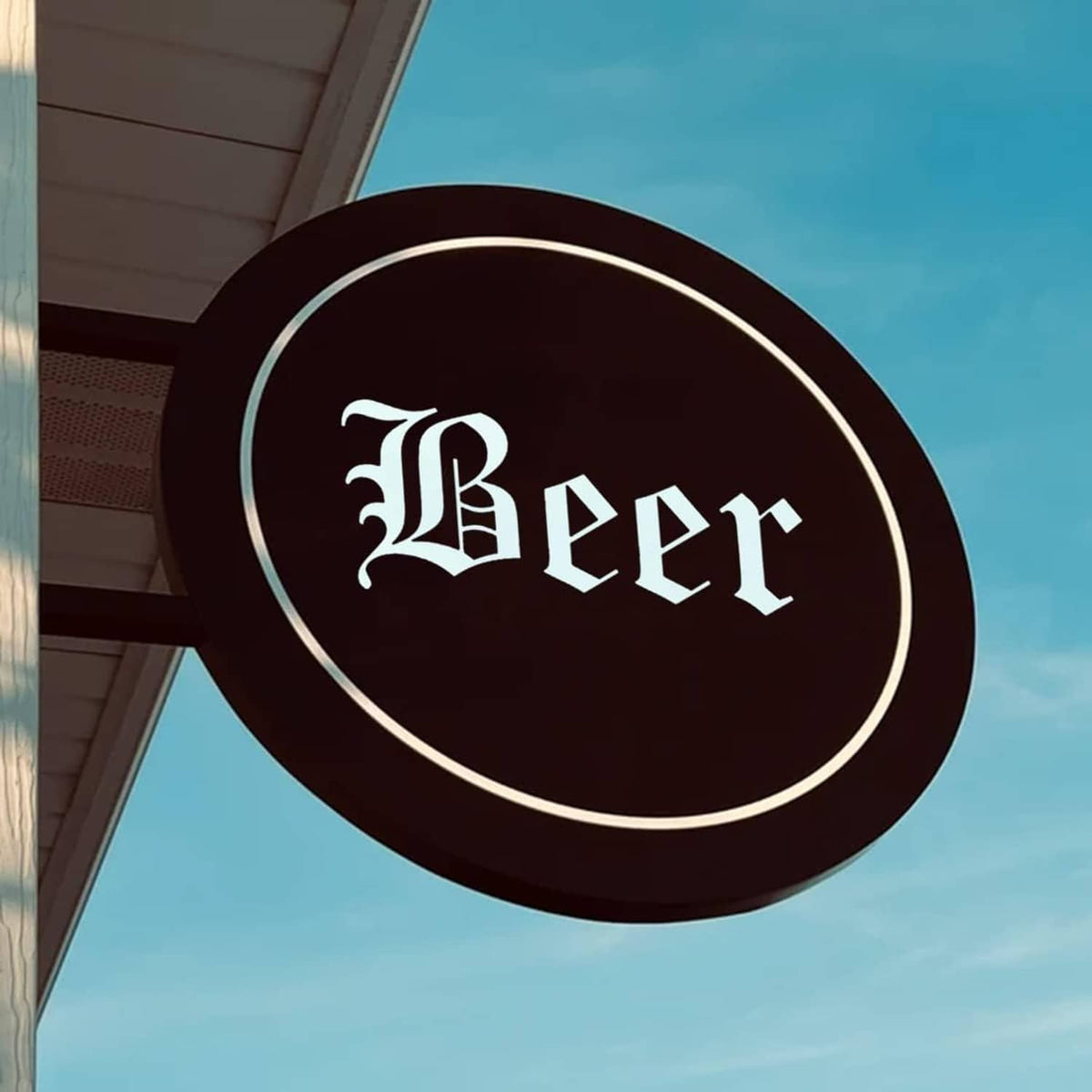Stencil letter design reading “Beer” on a round dark sign