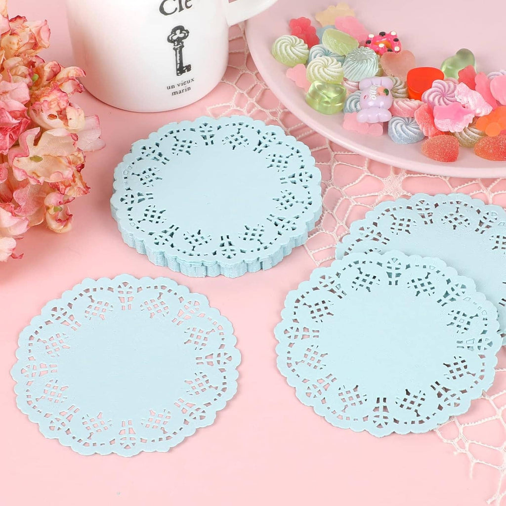Set of round light blue paper lace doilies with scalloped edges and cutout pattern