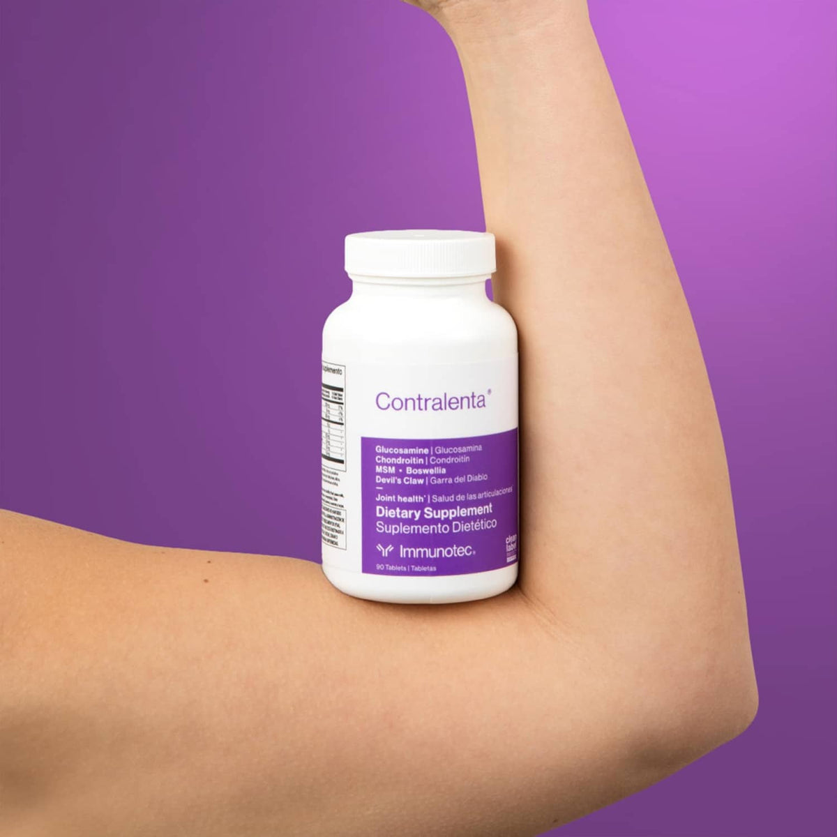 Dietary supplement bottle with front label held against forearm