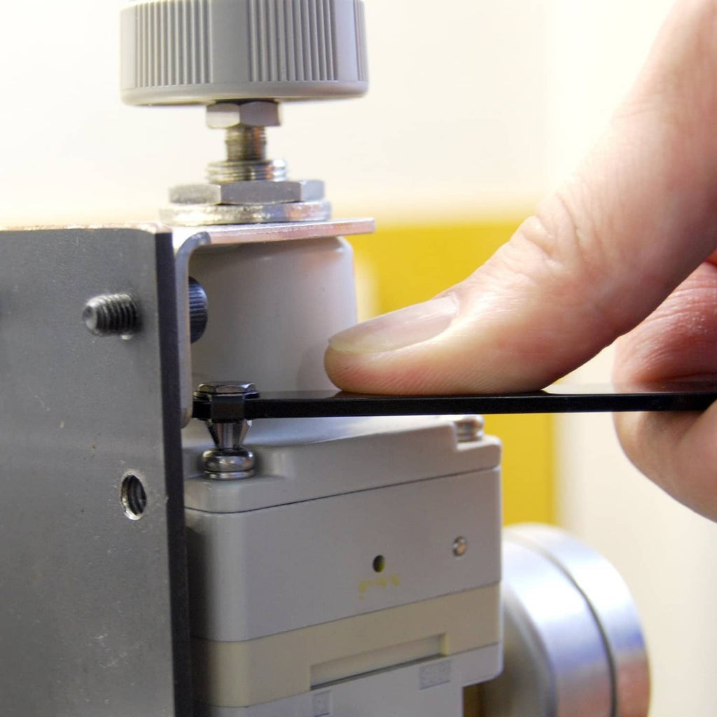 Slim offset screwdriver in use with long black shaft and metal tool tip