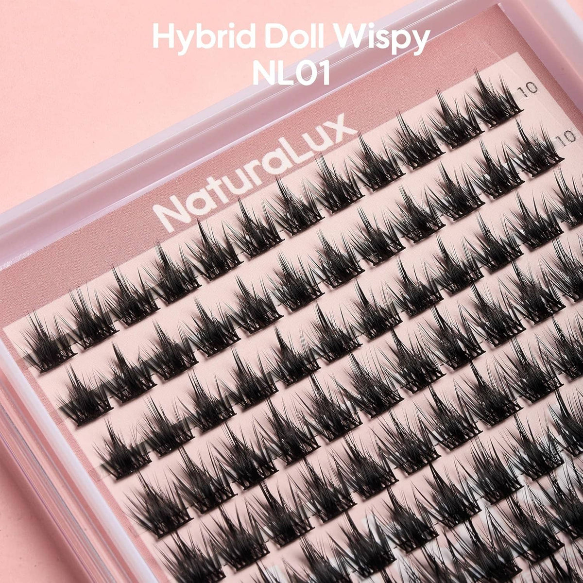 Close-up of wispy false eyelash extension strip set in a pink tray case