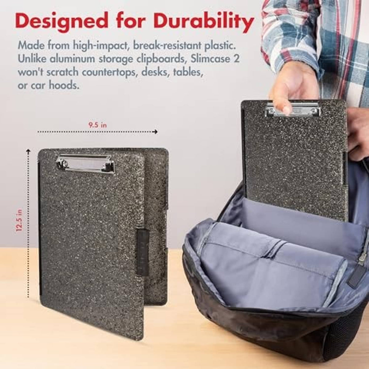 Speckled dark gray clipboard with metal clip and side latch, shown in use by hand