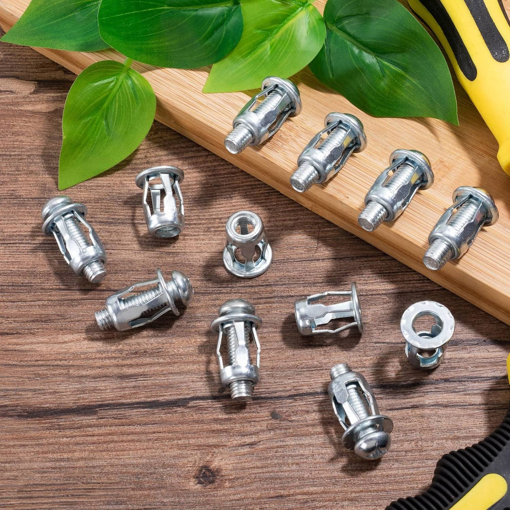 Silver expansion screws with petal nuts and washers on wooden board