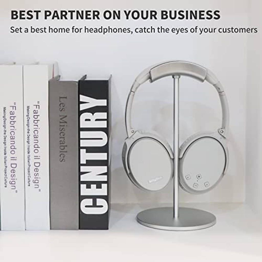 Silver headphone stand with gray-and-black over-ear headphones resting on a circular base