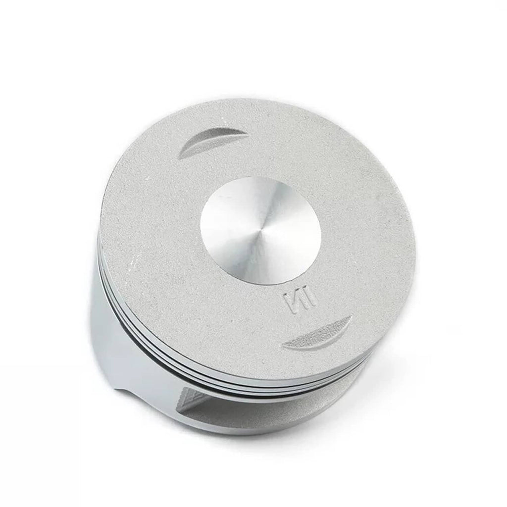 Silver piston with top cutouts and ring grooves around the skirt