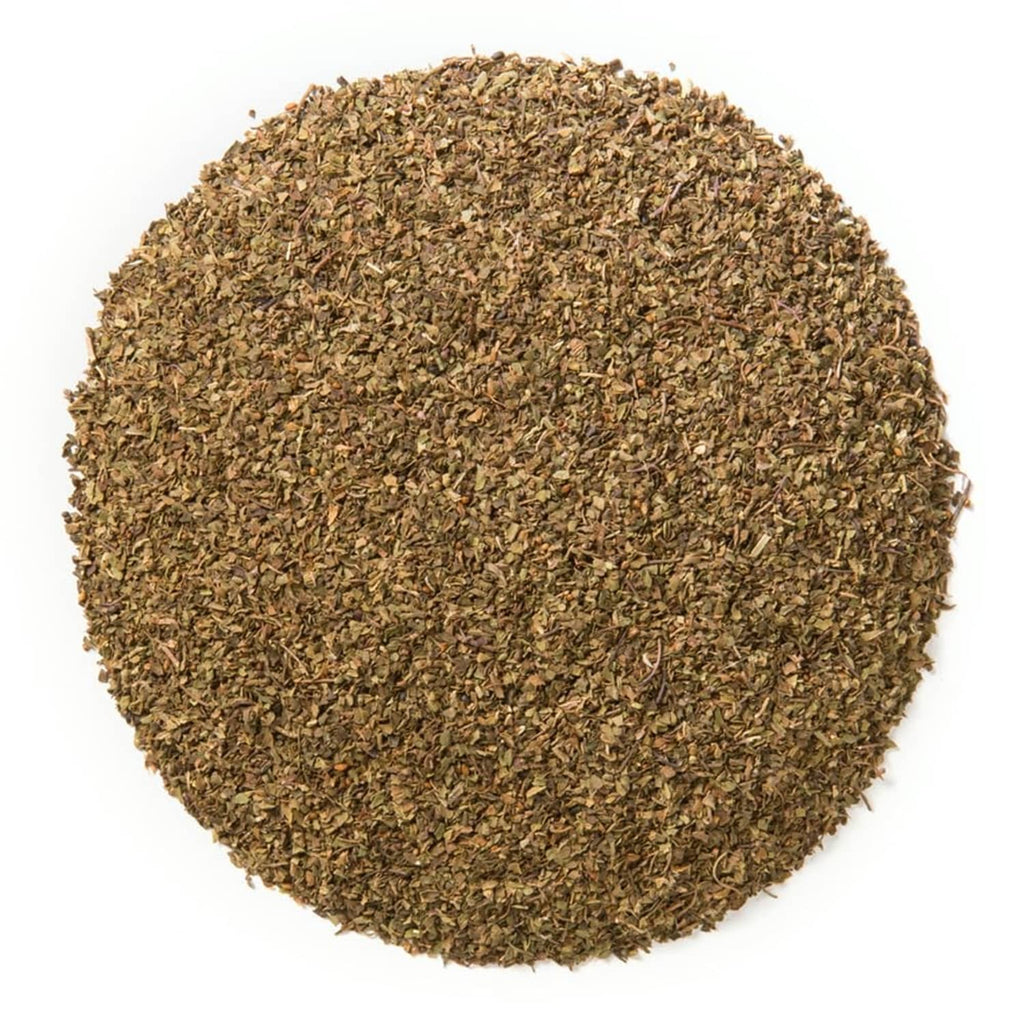 Loose leaf tulsi tea blend with coarse dried leaves, natural green-brown color.