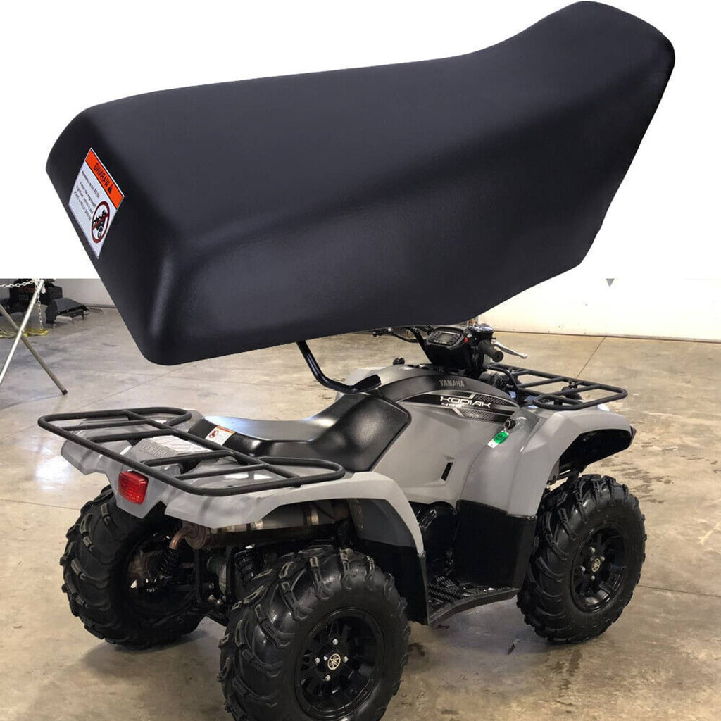Black ATV seat installed on ATV with rear rack; contoured padded top